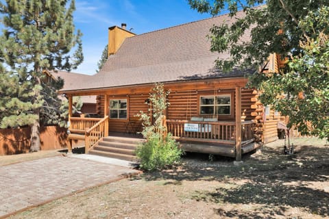 Welcoming cabin entry surrounded by towering pine trees, offering fresh mountain air and a peaceful forest setting—the perfect first impression for your Big Bear Lake getaway.