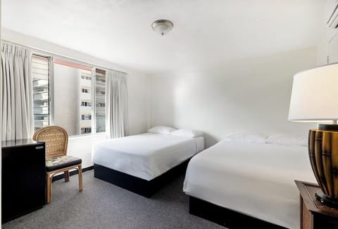 Unwind in bright twin beds with calming city views.