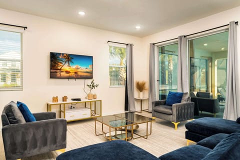 Relax in this stylish living room with plush seating and a large TV, perfect for unwinding after a day of exploring.