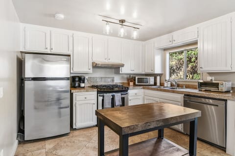 Seashore Delight’s fully equipped kitchen includes stainless steel appliances for hassle-free meal prep.