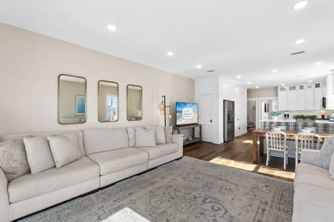 Relax in your spacious open-concept living room, where modern comfort meets elegant design with plush seating and seamless flow to the gourmet kitchen.