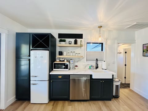 Gorgeous kitchen with vintage style fridge, farmhouse sink & quartz countertops
