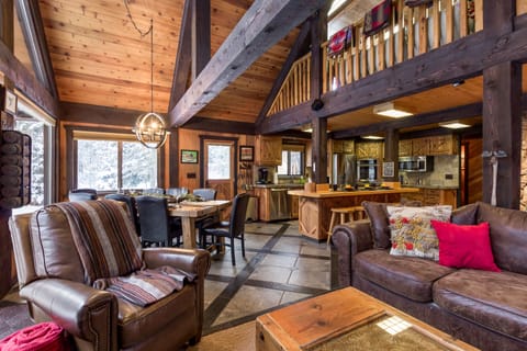 Step into the heart of Chandler's Lodge, where the living room and dining area merge seamlessly. It's a vibrant hub of laughter, delicious aromas, and unforgettable moments against a backdrop of breathtaking mountain vistas.