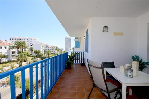 Spacious north-facing terrace with outdoor dining area and distant sea views