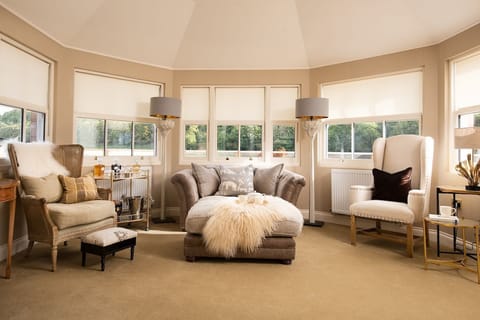 The Bothy at Dryburgh - the cosy conservatory with sofa and armchairs