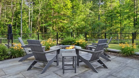 Fire pit overlooking backyard and pool area