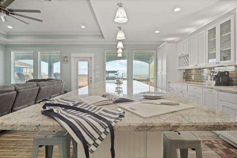 Feeling TipSea Kitchen: Retreat to your culinary oasis in this upscale kitchen, featuring designer finishes, such as brushed nickel hardware and handcrafted tile accents, creating a welcoming space to gather and savor the coastal lifestyle.