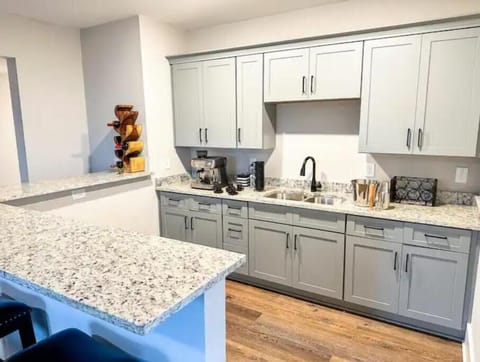 Kitchenette with espresso machine and bar seating