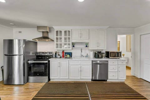 Full kitchen with refrigerator, stove and oven, dishwasher, microwave, coffee