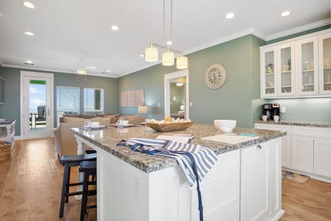 One TipSea Time Kitchen: Indulge in culinary delights in this opulent kitchen, boasting sleek granite countertops and custom-built cabinetry, set against gorgeous views of Crystal Beach.