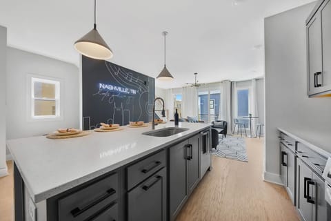 Clear sightlines from the spacious kitchen into the living room create an open and connected feel.
