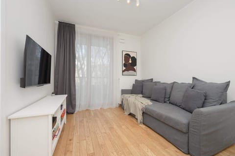 Living room with a Smart TV, sofa bed and exit to balcony.