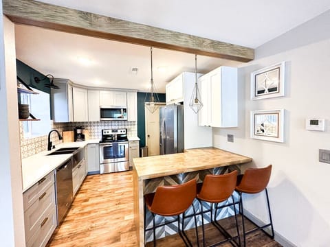 Modern kitchen with a sleek island—ideal for meal prep, casual dining, or gathering with friends! Enjoy a blend of style and functionality in this inviting culinary space.
