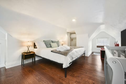 Large 3rd-floor bed room with king bed, crib, smart TV—perfect for the family.
