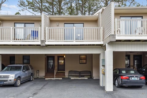 Multi-level townhome-style rental with private balconies, convenient parking, and tree-lined surroundings in a quiet residential setting.