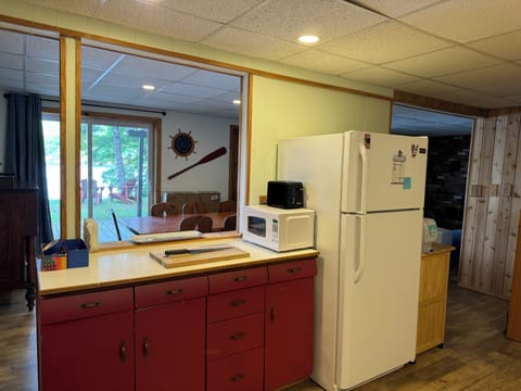 Kitchen opens into dinning area  - with 2 stools at the counter