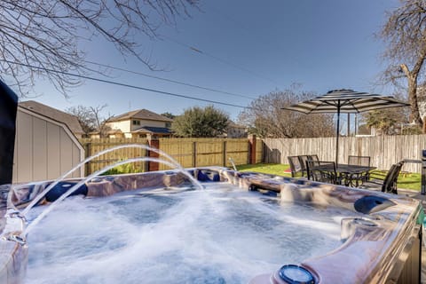 Hot tub off of patio in front of kitchen window