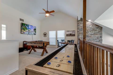 Game room with shuffleboard, foosball, board games, 70" TV