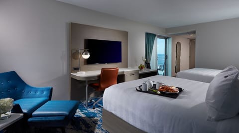 Enjoy breakfast in bed with entertainment and a sleek workspace.