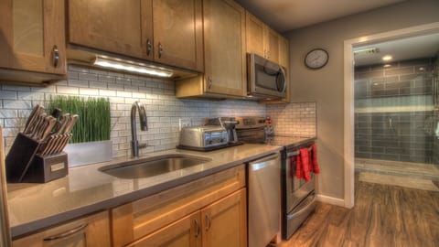 Our kitchen is outfitted with modern stainless steel appliances and features beautiful laminate flooring.