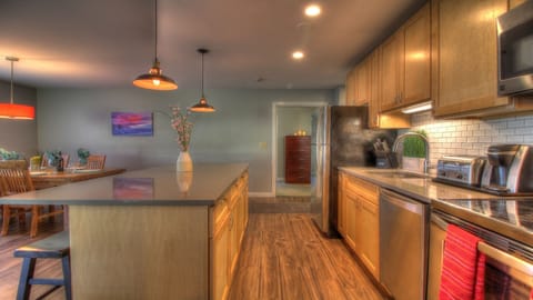 The property features a fully-equipped kitchen complete with a cozy dining area furnished with a table and chairs.