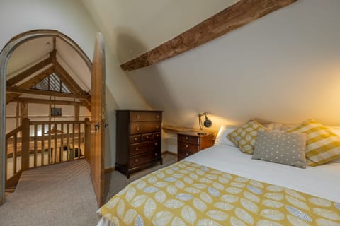 Bedroom two with a 4'6 double bed and exposed timbers