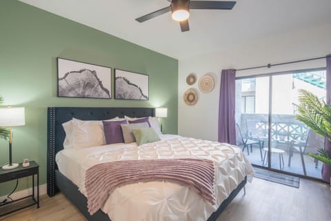Unwind in a serene bedroom featuring a comfy queen bed, soft linens, and curtains for restful sleep.