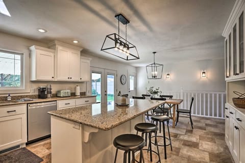 Kitchen and dining space with cabinetry and direct patio access.