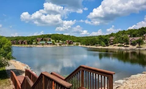 Fishing lake with walking path. Adjacent is the pool, sand court, and basketball