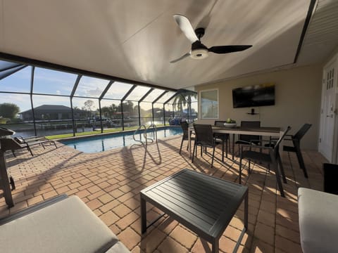 Kick back on the lanai 😎 — peaceful canal views, shaded lounge, and outdoor dining just steps from the pool