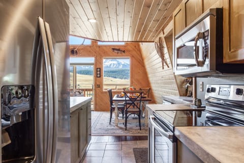 The kitchen at Mountain Lake Lodge boasts sleek stainless steel appliances, elevating your culinary experience. Prepare delicious meals in style while enjoying the stunning views of Henry's Lake.