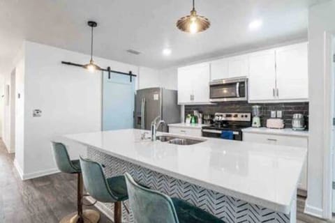 Kitchen: Modern design with sleek appliances and stylish seating for delightful meals together!