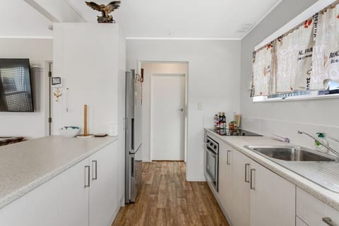 The galley-style kitchen has an oven, cooktop, microwave, dishwasher and fridge/freezer.