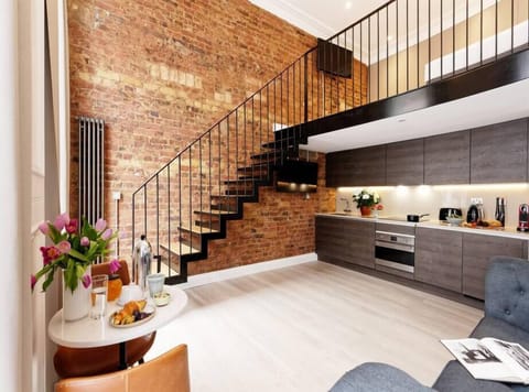 Open space with private kitchen area fully equipped with washing machine-dryer, oven-microwave, stove, kettle, toaster, Nespresso coffee machine, and kitchenware. Salt and pepper included. Non-included oils or food.