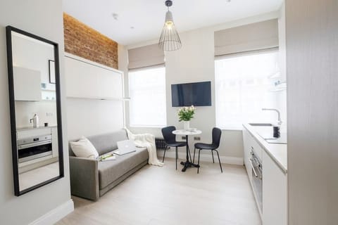 Living room area, with comfortable wall bed. Latest technology system, easy to use and space efficient to enjoy as much as possible your stay. The wall bed can be easily folded into a comfortable sofa for your commodity.