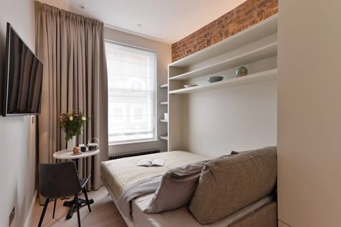 Comfortable double bed. Please, note that the bed will be open and ready for your arrival. It's a wall bed, with the newest technology available. Super convenient and space-efficient!