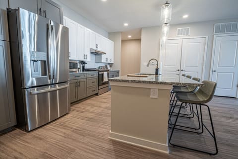 Welcome to our open kitchen! Fully equipped with sleek stainless steel appliances and ample counter space, it`s perfect for cooking and quick meals.
