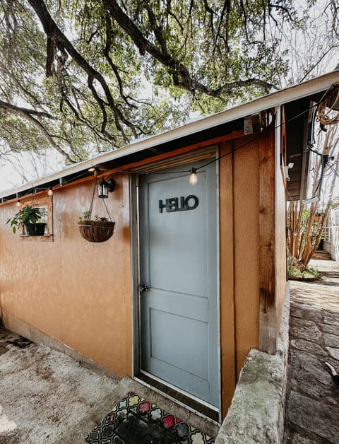Side entrance to Carriage House facing the private patio w/ fire pit.