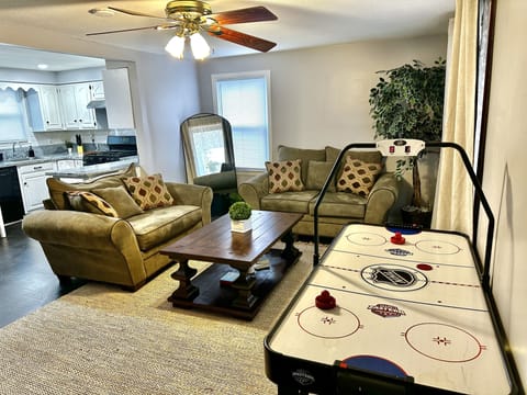 Living room, two comfortable heavy couches, large table, standing mirror
