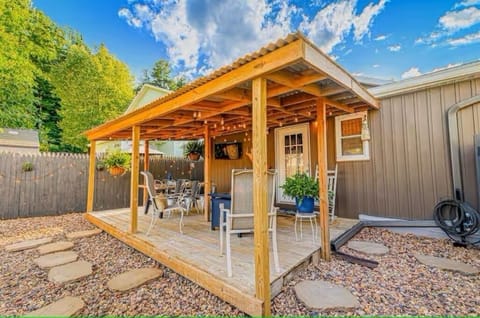 Relax on the covered back deck with a fire table, dining table, and smart TV.