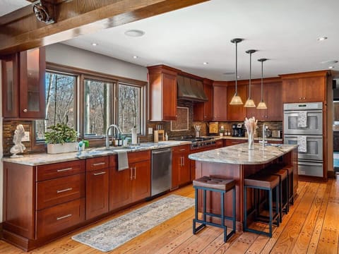 Large kitchen w/ central island, ample cabinetry & seating for casual meals.