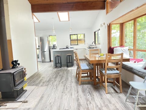 Dining and kitchen areas with window seat. Table can be expanded to set up to 10