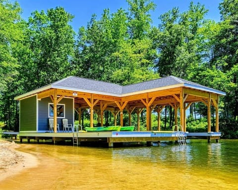 Charming lakeside boathouse with seating area and easy water access, perfect for relaxation and recreation