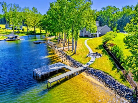 From Above - The full property in a single frame: private dock, sandy beach, fire pit, and quiet cove out front.