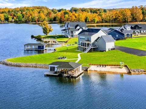 A stunning lakeside property with a private boathouse, sandy beach, and spacious yard, ideal for a perfect waterfront getaway