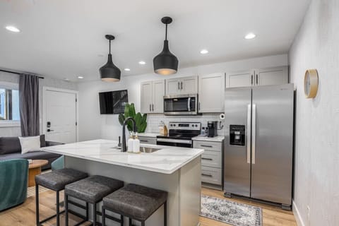 Fully-stocked modern kitchen with all the appliances and utensils you might need to enjoy a meal at home. Coffee provided for the Keurig and seating for 3 at the kitchen counter.