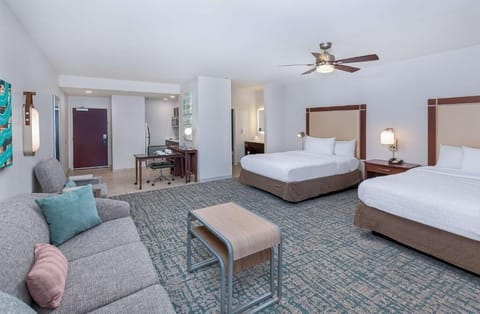 Recharge in a roomy suite with lounge seating and workspace.