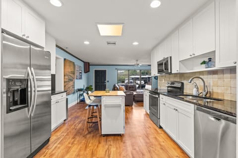 The modern kitchen with white cabinets, modern appliances, and a countertop. It's the perfect spot for cooking and entertaining!
