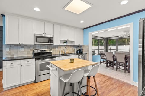 The modern kitchen with white cabinets, modern appliances, and a countertop. It's the perfect spot for cooking and entertaining!