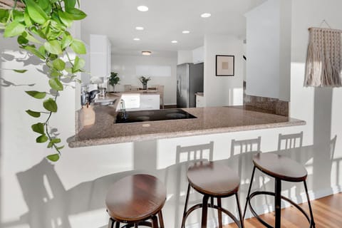 Have a few drinks at the kitchen bar while watching the family chef in action.